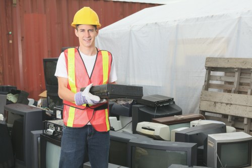 Team sorting items for recycling and reuse in a home clearance